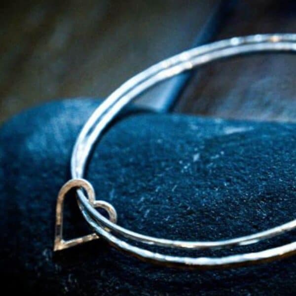 Silver hammered double bangle connected with a love heart